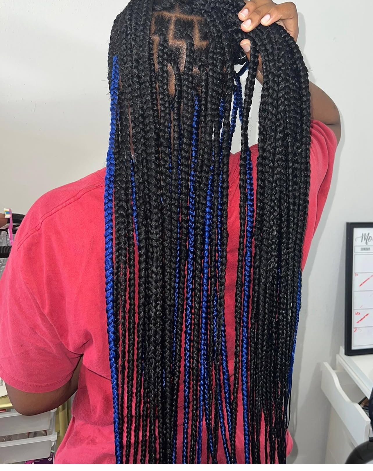 Long dark box braids with blue highlights