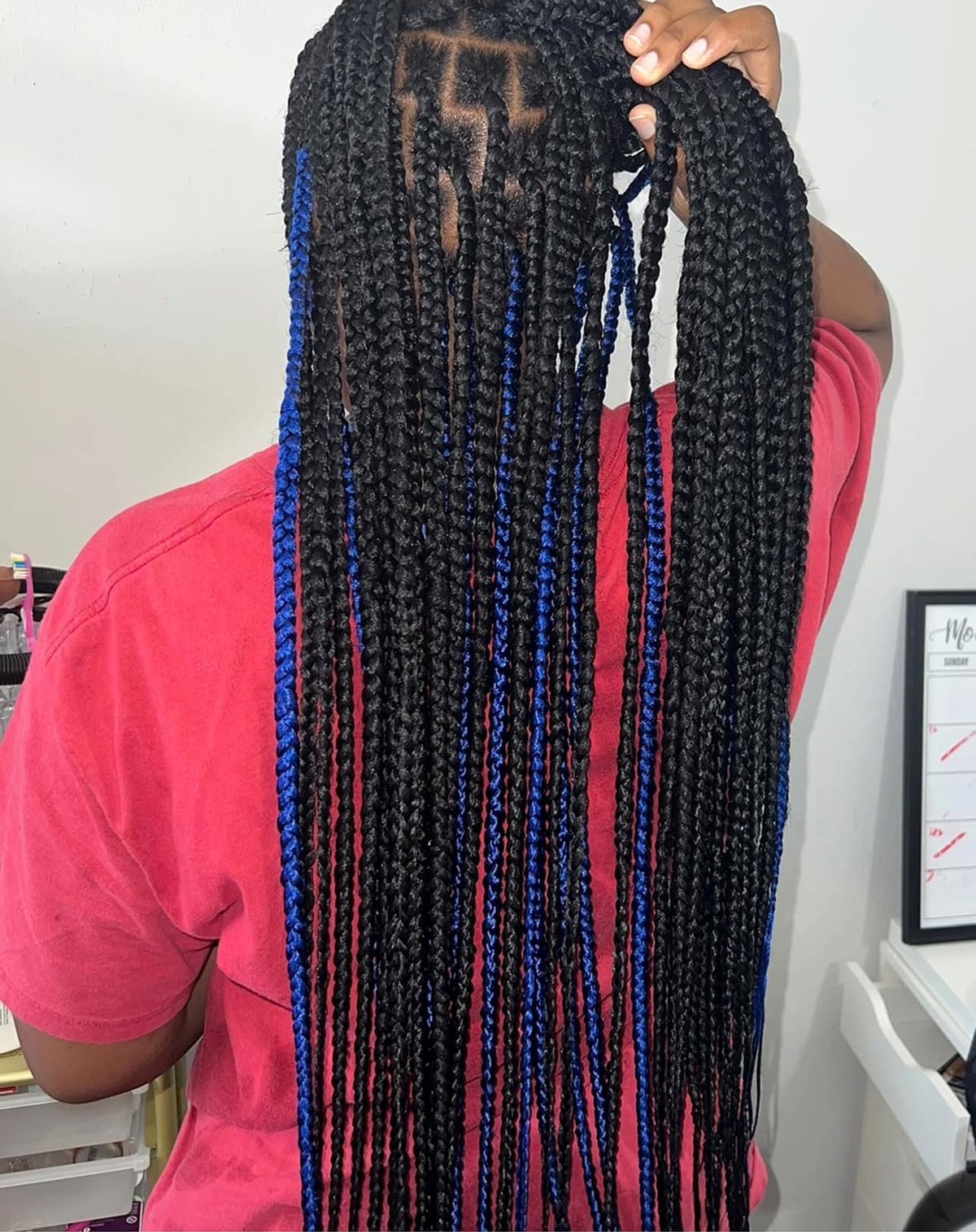 Long dark box braids with blue highlights