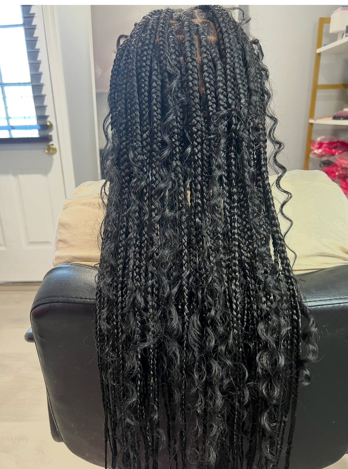 Long dark box braids with curly ends, full view