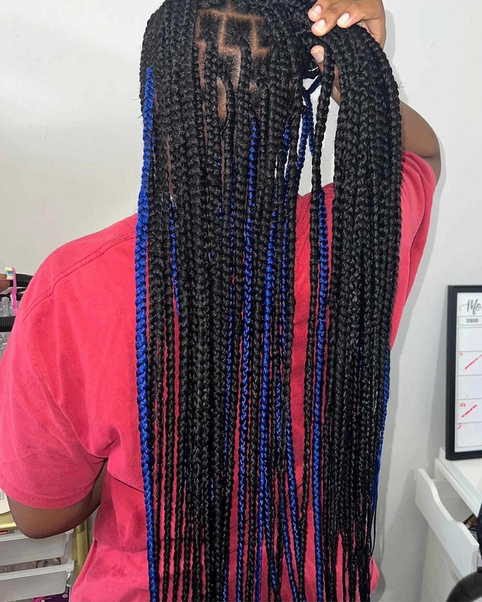 Long dark box braids with blue highlights