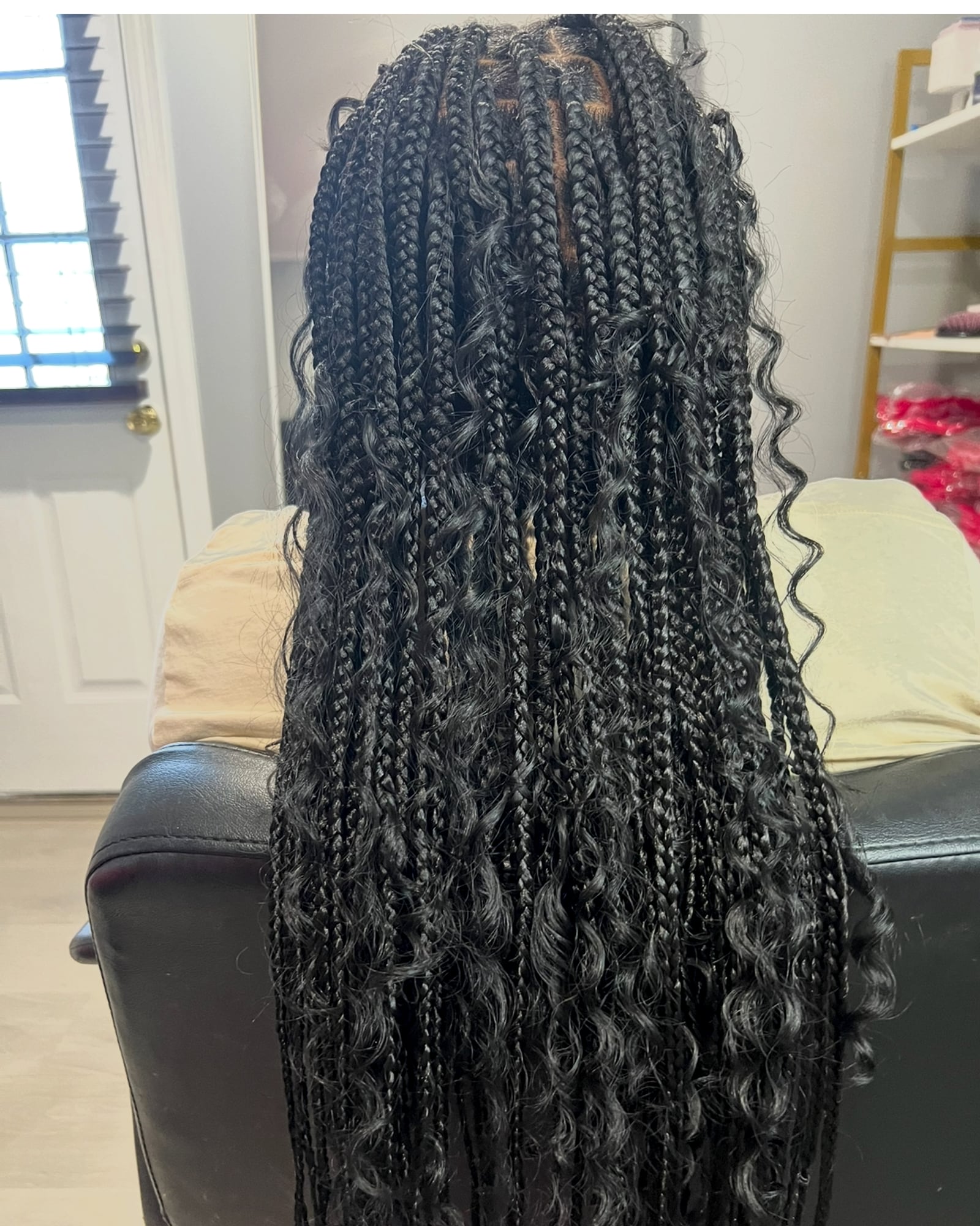 Long dark box braids with curly ends, full view