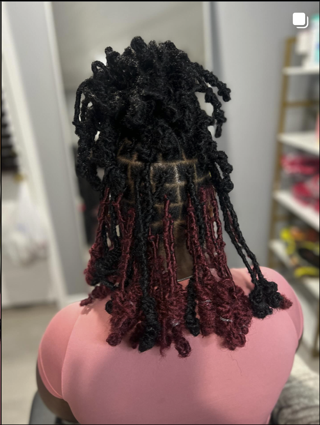 Close-up of black and red mixed locs/braids with curly ends